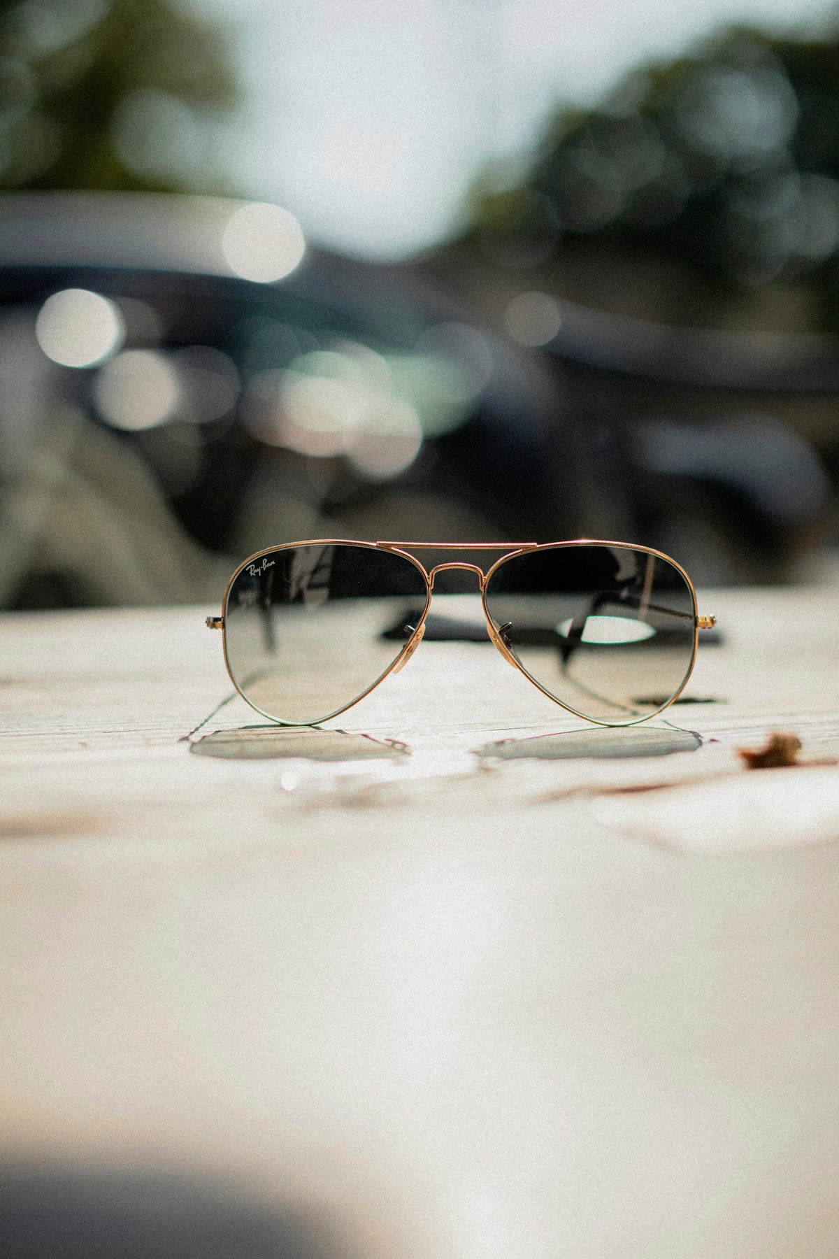Gold aviator sunglasses on a café table