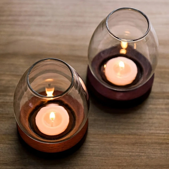 Faro glass candle holders glowing on a table