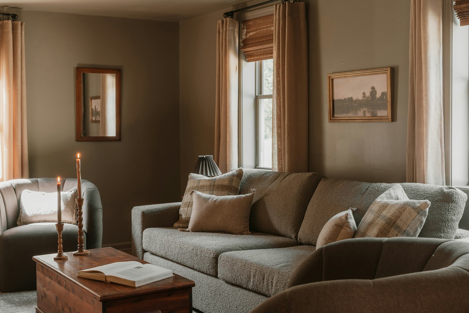 A cozy neutral living room with a sofa and armchair