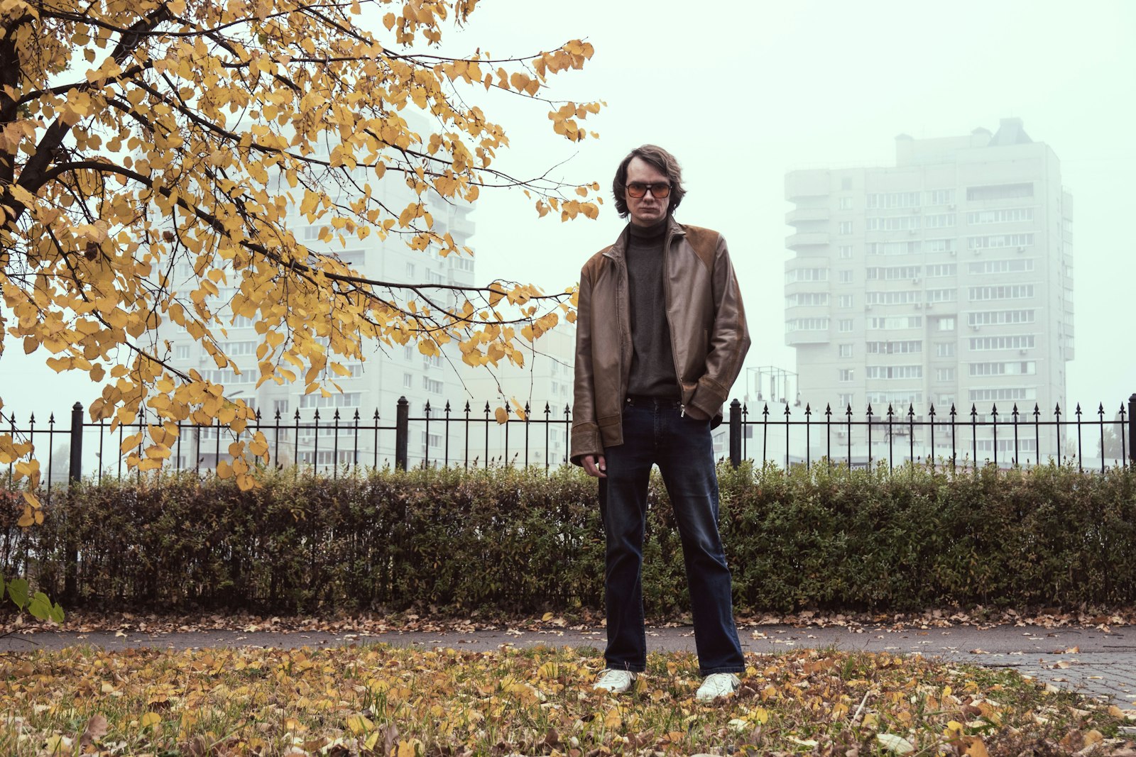 Man in a brown leather jacket in an autumn park — how to wear a leather jacket, men's guide