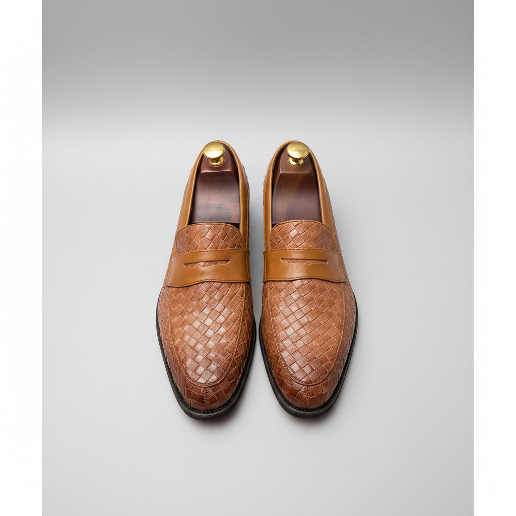 Brown woven loafers on a grid background