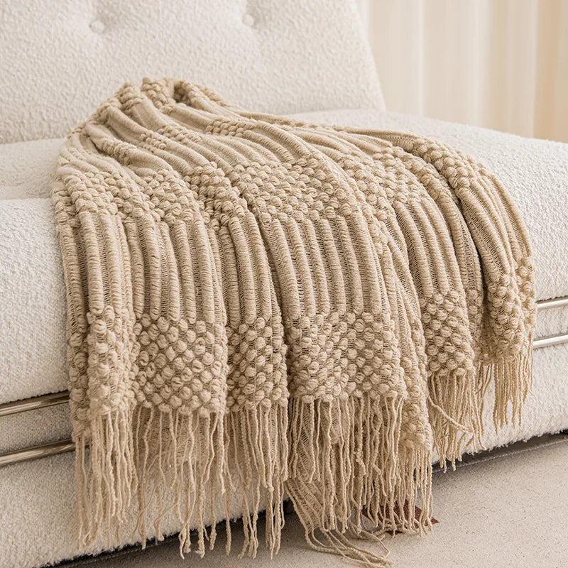 Alpi knit throw draped on a chair