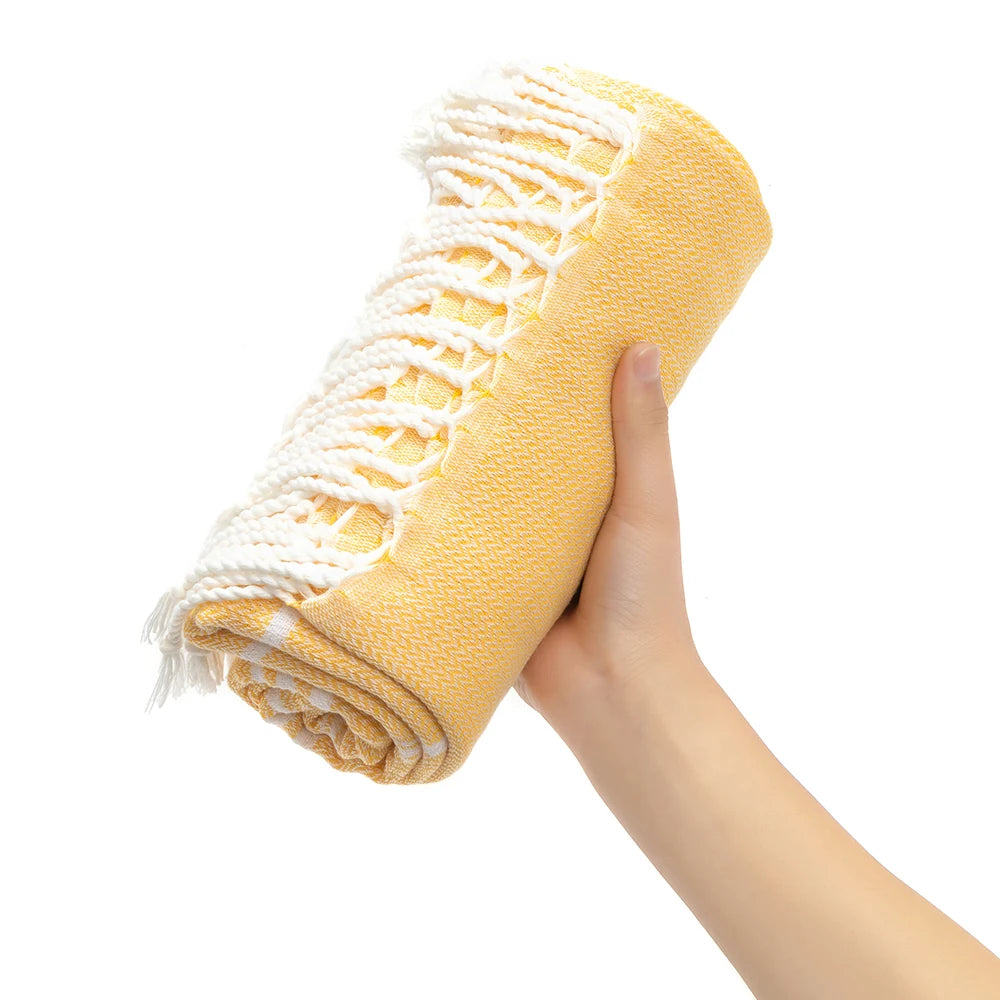 Holding a rolled Amalfi towel
