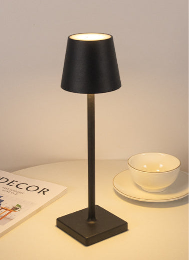Bellagio cordless table lamp in Black, lit with a warm glow