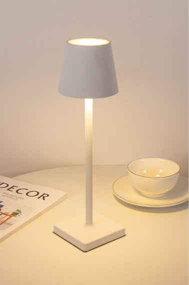 Bellagio cordless table lamp in White, lit with a warm glow