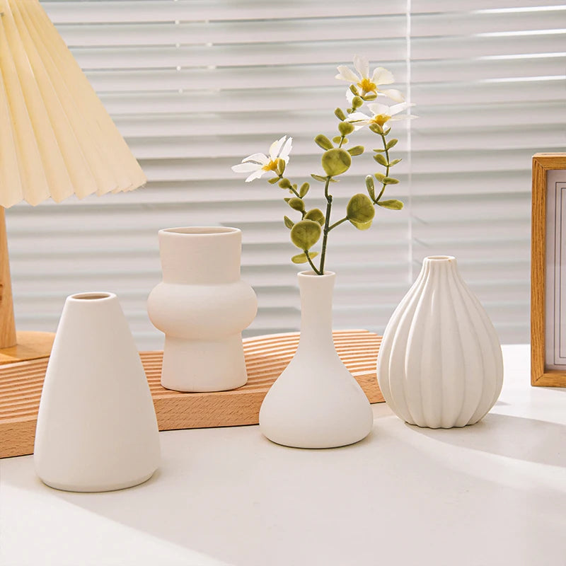 Bianca vases with flowers by a window