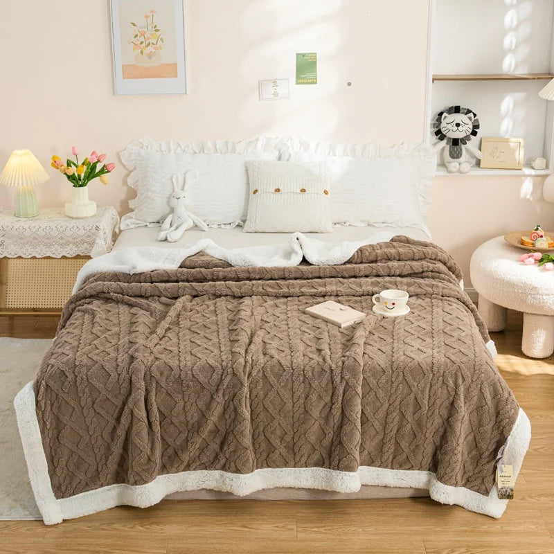 Brunico cable knit sherpa blanket on a bed