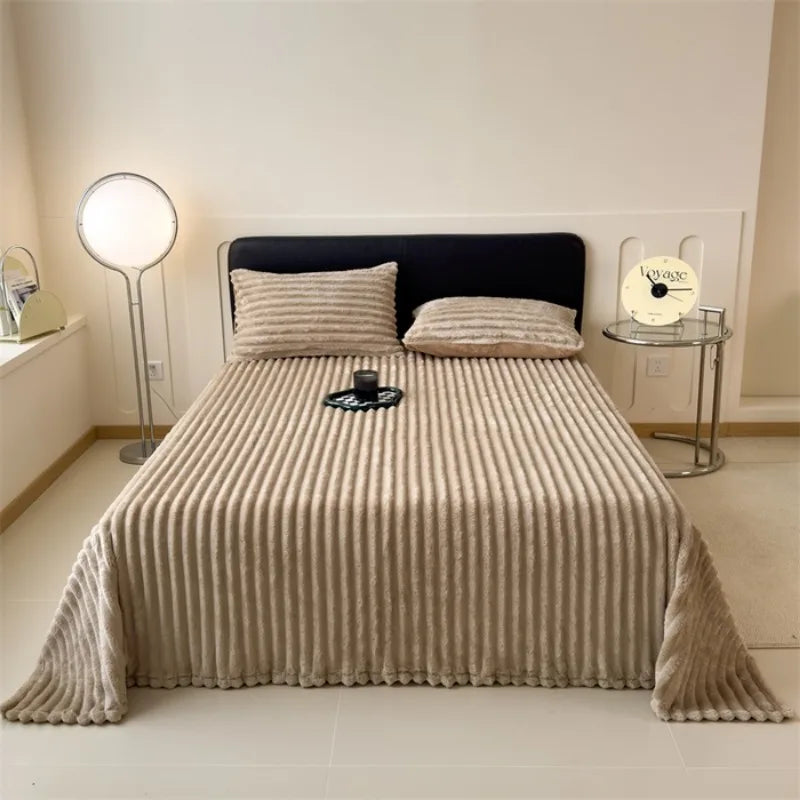 Cortina faux fur throw in khaki on a bed