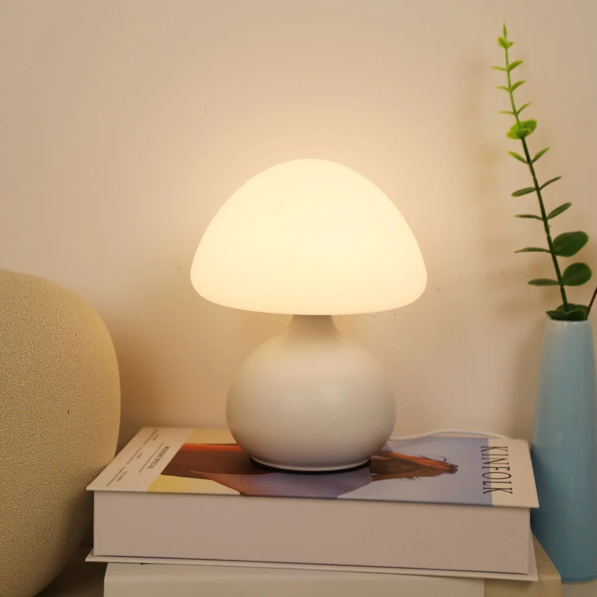 Funghetto lamp glowing on books