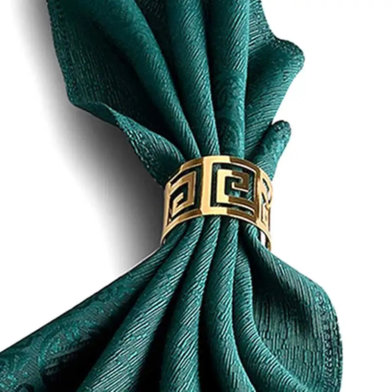 Greca gold Greek key napkin ring on a green napkin