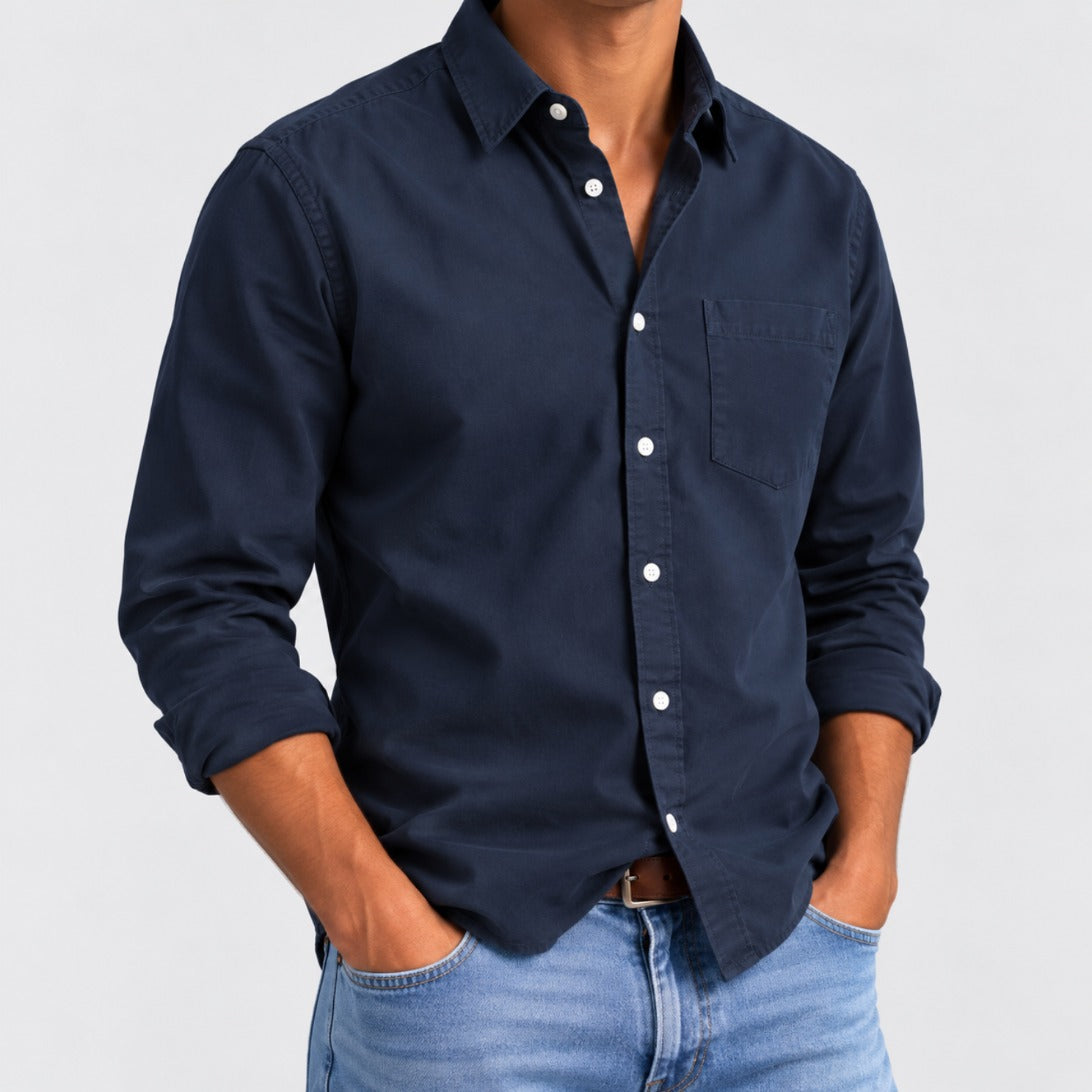 Hudson men's classic button-up shirt in Ocean Navy, worn with jeans