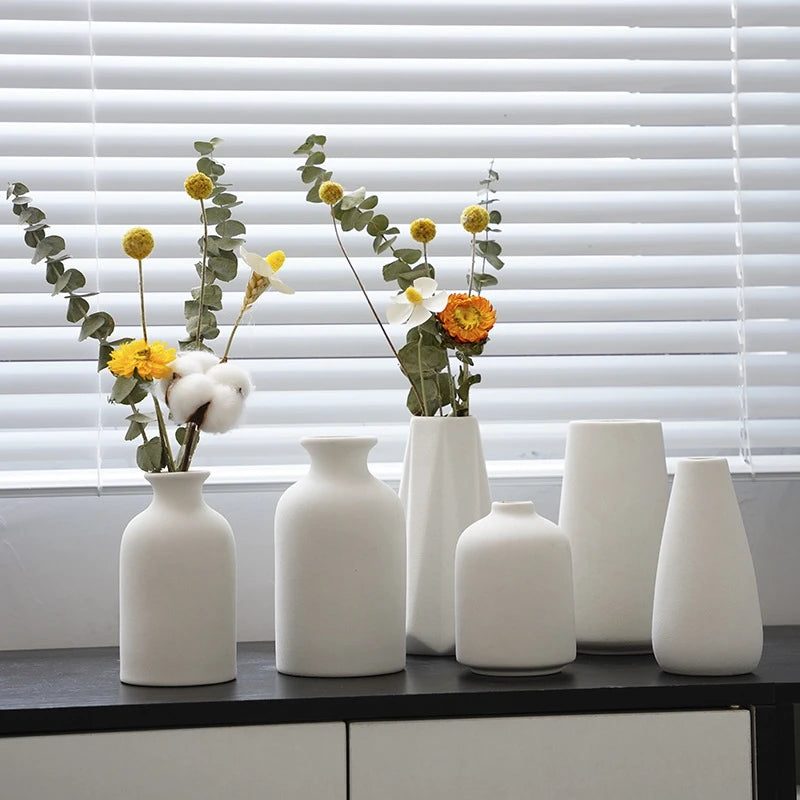 Latte white bud vases on a windowsill