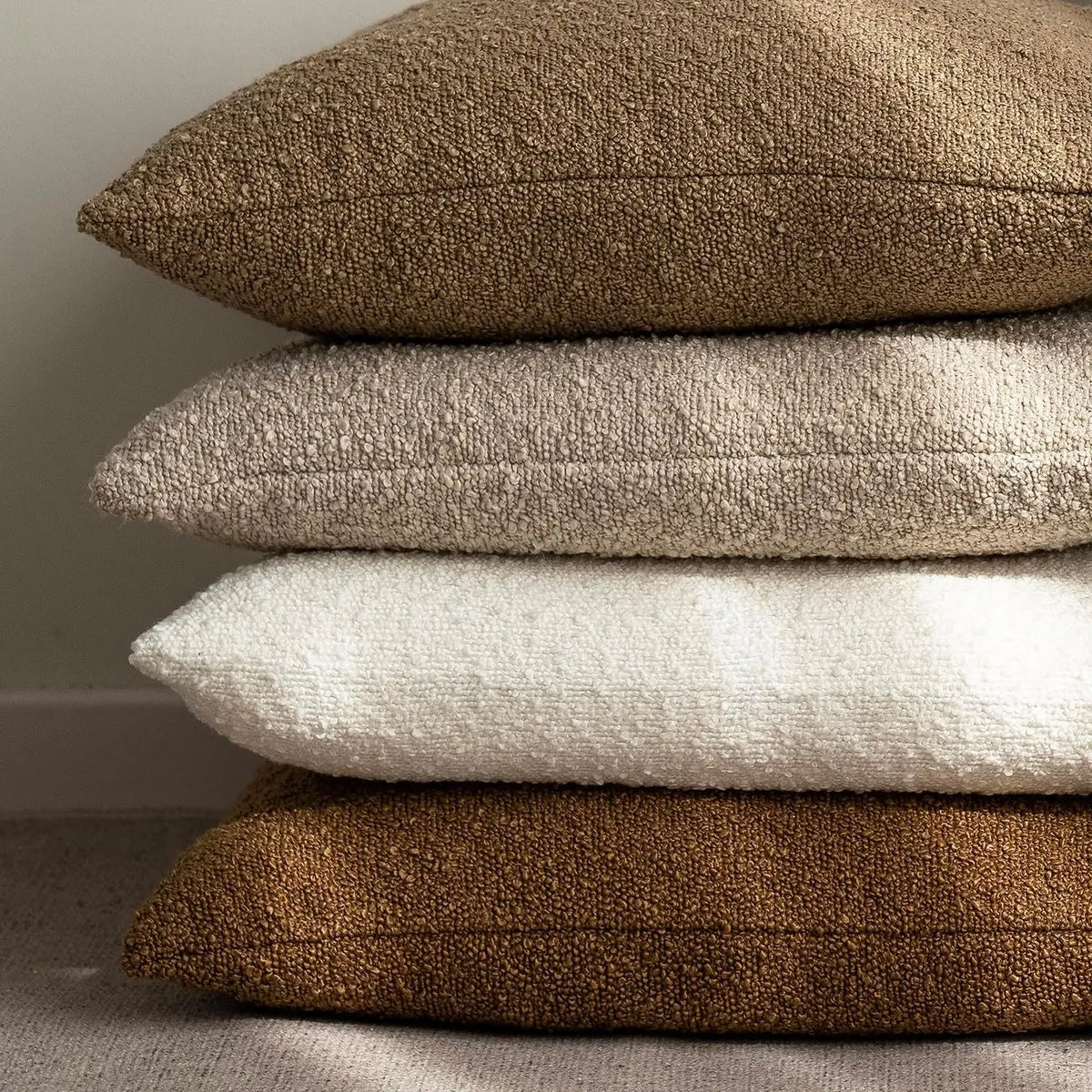 Stack of Morbido bouclé cushions