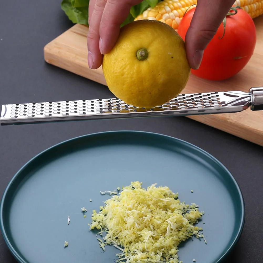 Scorza grating citrus over a plate