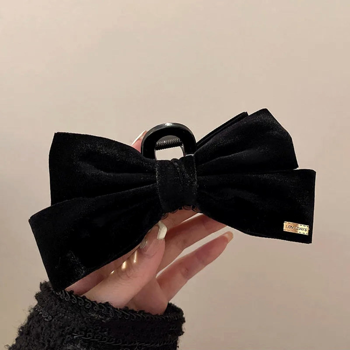 Serena Velvet Bow Claw Clip in hand