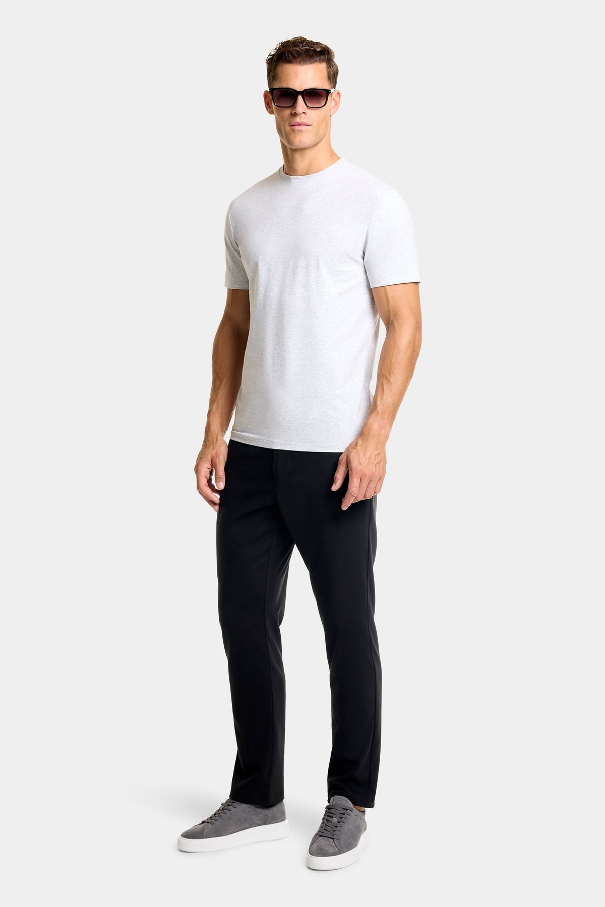 Man wearing the Jackson slim chino pants in Black with a white tee